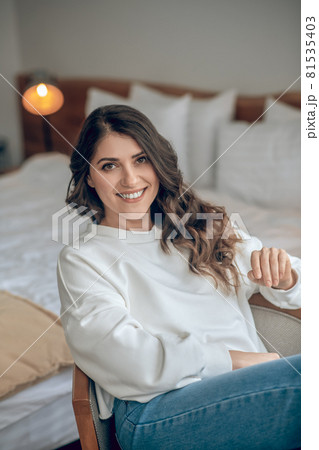 Pretty young long-haired woman in a white blouse 81535403