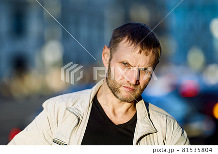 Portrait of frowning white man with stubble on face. Portrait of frowning white man with stubble on face. 81535804