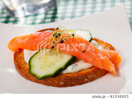 Sandwich with salmon, cucumber, sauce Sandwich with salmon, cucumber, sauce 81536925