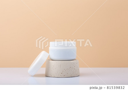 White cosmetic jar on gypsum podium against pastel beige background with copy space 81539832