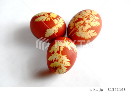 Painted Easter eggs on a white background. Floral pattern on a red eggshell. Festive food. Painted Easter eggs on a white background. Floral pattern on a red eggshell. Festive food. 81541163
