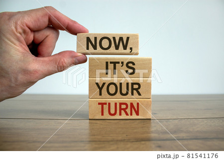 Wooden blocks form the words 'now, it's your turn' on beautiful wooden table. White background. Male hand. Business concept. Wooden blocks form the words 'now, it's your turn' on beautiful wooden table. White background. Male hand. Business concept. 81541176