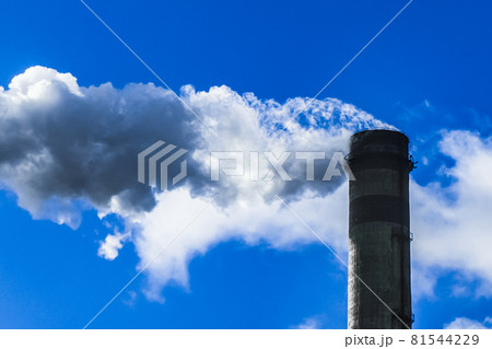 Environmental pollution, environmental problem, smoke from the pipe of an industrial plant or thermal power plant against a blue sky 81544229