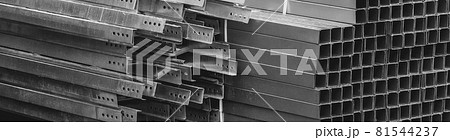 A pile of metal plates and square industrial pipes. Building materials at the construction site 81544237