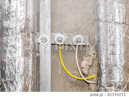 Yellow insulating electric wire cables and metal pipes, construction toilet repair 81544251