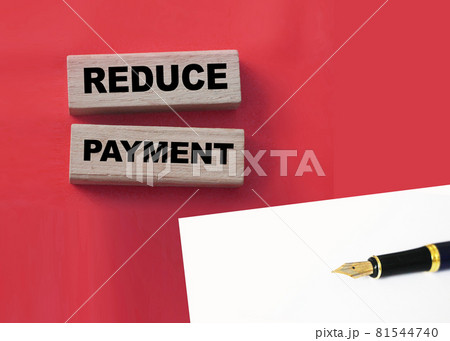 Wooden blocks with the words Reduce payment. Business concept 81544740