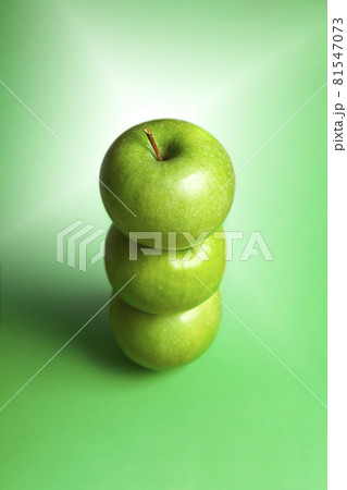 tower of 3 whole isolated granny smith green apple on green background 81547073