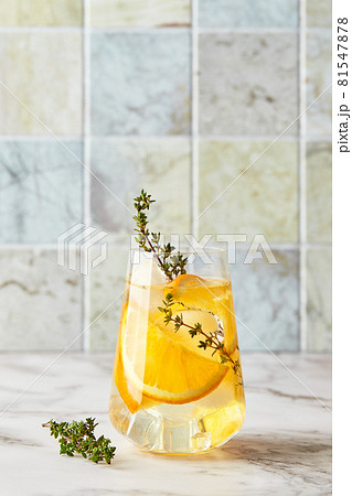 Refreshing cocktail with ice, orange and thyme. Refreshing summer homemade alcoholic or non-alcoholic cocktail or mocktail, or Detox infused flavored water 81547878