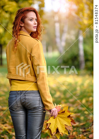 autumn woman on leafs. Park  81548374