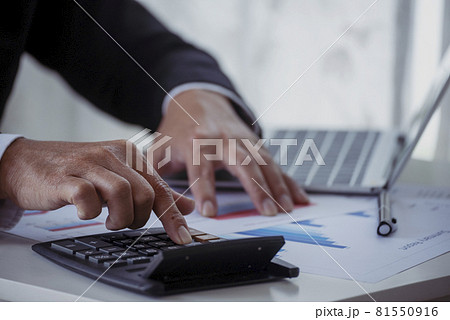 Close up business man hands using calculator counting tax financial bill. Man hands calculating number, data, graph, chart audit planning accountancy on business report. Tax audit Finacial concept. Close up business man hands using calculator counting tax financial bill. Man hands calculating number, data, graph, chart audit planning accountancy on business report. Tax audit Finacial concept. 81550916