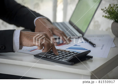 Close up Man hands calculating number, data, graph, chart audit planning accountancy on business report. Business man hands using calculator counting tax financial bill. Tax audit Finacial concept. Close up Man hands calculating number, data, graph, chart audit planning accountancy on business report. Business man hands using calculator counting tax financial bill. Tax audit Finacial concept. 81550917
