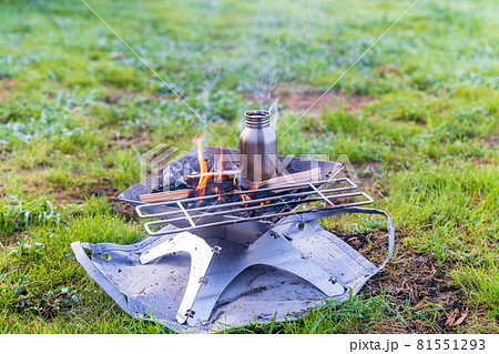 焚き火台で焚火と湯沸かしの写真素材