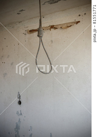 Deadly loop hanging from the ceiling in abandoned apartment. Concept of suicide, despair 81551771