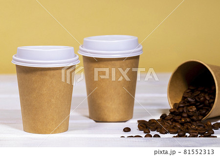 Coffee to go in paper eco cup with coffee bean on wooden and light orange background, Fast food, Copyspace Coffee to go in paper eco cup with coffee bean on wooden and light orange background, Fast food, Copyspace 81552313