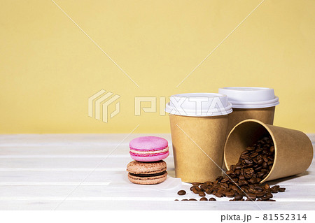 Coffee to go in paper eco cup with french macaroon on wooden and light orange background, Fast food, Copyspace, Caffeine Drink take away, Bean Coffee to go in paper eco cup with french macaroon on wooden and light orange background, Fast food, Copyspace, Caffeine Drink take away, Bean 81552314
