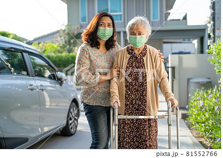 Asian senior or elderly old lady woman walk with walker and wearing a face mask for protect safety infection Covid-19 Coronavirus. Asian senior or elderly old lady woman walk with walker and wearing a face mask for protect safety infection Covid-19 Coronavirus. 81552766
