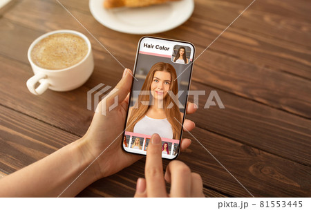 Caucasian woman choosing new hair color, using mobile app 81553445