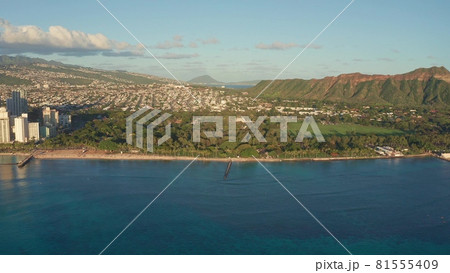 A drone view at sunset of Waikiki Beach and Diamond Head Crater, a famous tourist destination in Honolulu, Oahu, Hawaii, USA. Waikiki Beach, Honolulu skyline in the background. A drone view at sunset of Waikiki Beach and Diamond Head Crater, a famous tourist destination in Honolulu, Oahu, Hawaii, USA. Waikiki Beach, Honolulu skyline in the background. 81555409