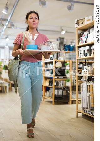 Portrait of woman walking through the store with purchases Portrait of woman walking through the store with purchases 81562190