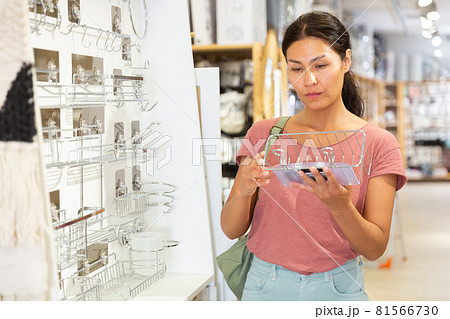 Asian woman choosing accessories for bathroom 81566730