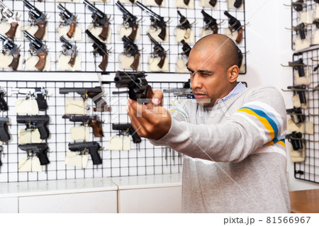 Choosing a revolver in gun shop closeup Choosing a revolver in gun shop closeup 81566967