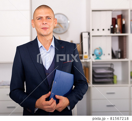 Portrait of positive business man with folder of documents 81567218
