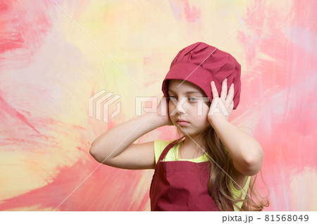 kid, serious girl cook in red chef hat, apron kid, serious girl cook in red chef hat, apron 81568049