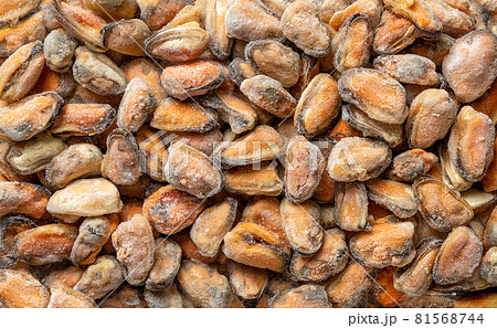Frozen peeled mussel meat as background for seafood recipes. Iced cooked mussels texture . Frozen peeled mussel meat as background for seafood recipes. Iced cooked mussels texture . 81568744