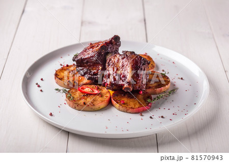Hot Meat Dishes. Pork ribs grilled with peppers and apples Hot Meat Dishes. Pork ribs grilled with peppers and apples 81570943