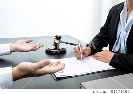 A woman lawyer or a judge counseling clients about judicial justice and prosecution with scales, judges gavel, legal documents legal services concept A woman lawyer or a judge counseling clients about judicial justice and prosecution with scales, judges gavel, legal documents legal services concept 81571160
