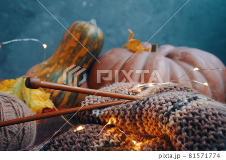 Autumn decoration with yarn, wooden needles, lights and colorful pumpkins. Autumn decoration with yarn, wooden needles, lights and colorful pumpkins. 81571774
