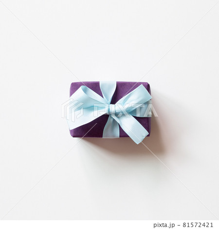 Purple gift box with blue ribbon isolated on white background. top view, copy space Purple gift box with blue ribbon isolated on white background. top view, copy space 81572421