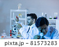 Team of research scientists analysing test trial new generation vaccine data. 81573283