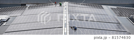Engineering install Solar Cell system on a Roof top of the building to absorb sunlight as a source to generate electricity. 81574630
