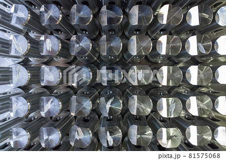 Batch of shiny metal parts after cnc turning and milling top-down view with selective focus. 81575068