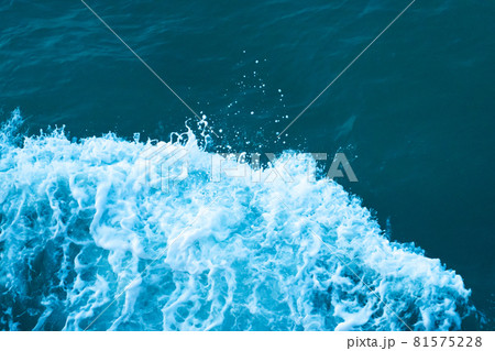 White crest of a wave in the dark turquoise water of the ocean White crest of a wave in the dark turquoise water of the ocean 81575228
