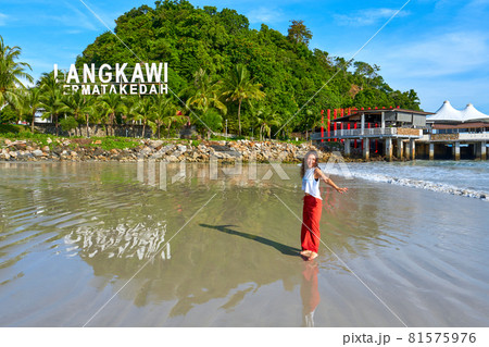 happy tourist woman enjoy travel on the central beach in Langkawi tropical island 81575976