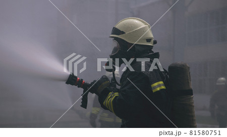 Fireman training with water hose Fireman training with water hose 81580751