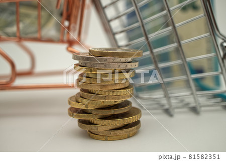 Stack of coins against a backdrop of silver and copper metal Stack of coins against a backdrop of silver and copper metal 81582351