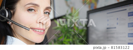 Young woman in headphones with microphone sitting in front of computer screen Young woman in headphones with microphone sitting in front of computer screen 81583122