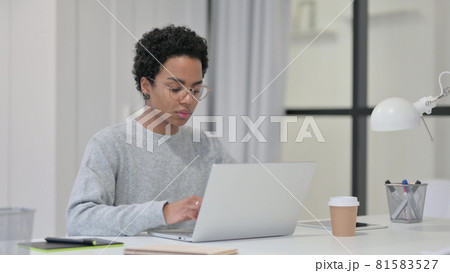 African Woman Working on Laptop in Office African Woman Working on Laptop in Office 81583527
