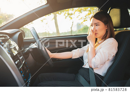 Young Asian woman holding her nose because of bad smell after turn on car air conditioning Young Asian woman holding her nose because of bad smell after turn on car air conditioning 81583728