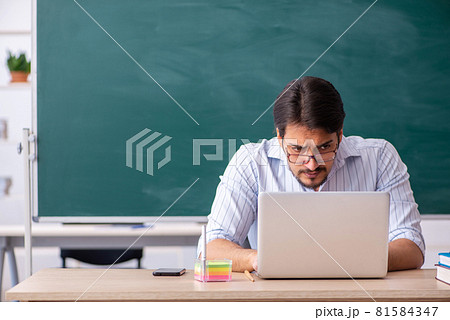 Young male teacher in telestudying concept 81584347