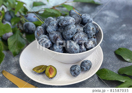 Plums on a light background. Harvesting the autumn harvest. Making jam and sauce. Still life. Plums on a light background. Harvesting the autumn harvest. Making jam and sauce. Still life. 81587035
