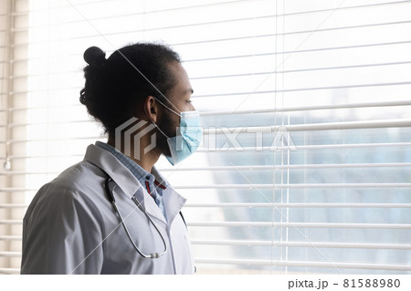 Pensive young african american doctor looking in distance. Pensive young african american doctor looking in distance. 81588980