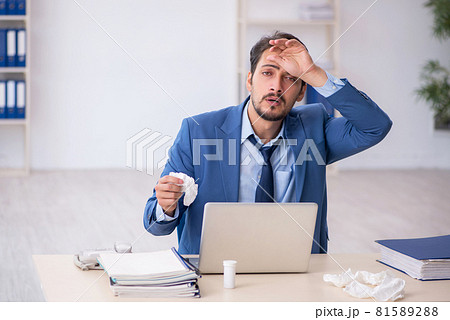 Young male employee suffering at workplace 81589288