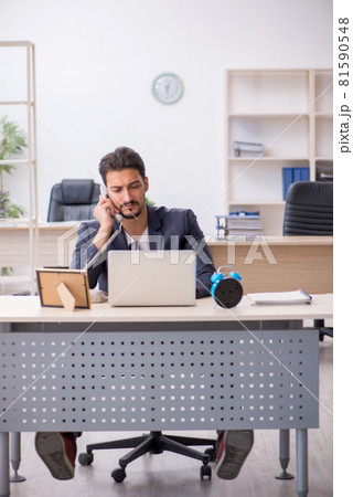 Young handsome employee working in the office Young handsome employee working in the office 81590548