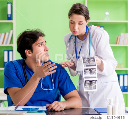 Woman and man gynecologists discussing medical case at the clini Woman and man gynecologists discussing medical case at the clini 81594956