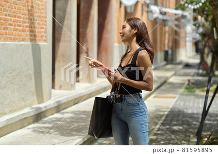Asian young female tourist using smartphone for directing destination 81595895