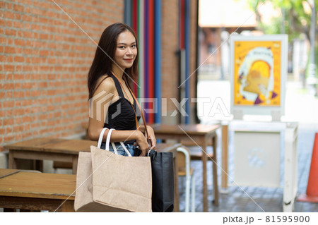 Young woman with shopping bags, shopaholic woman in summer 81595900